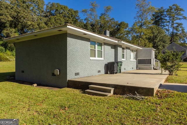 back of property featuring a patio and a lawn