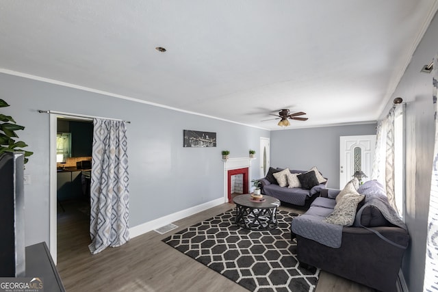 living room with crown molding, hardwood / wood-style flooring, and ceiling fan