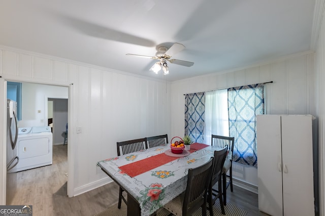 dining space with ceiling fan, crown molding, washer / clothes dryer, and wood-type flooring