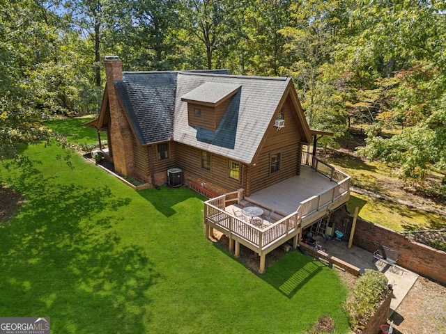 rear view of house featuring a yard, a wooden deck, and central AC unit