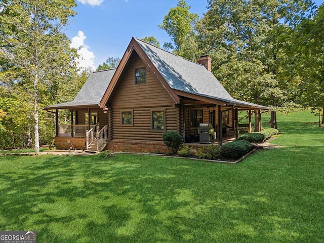 view of side of home with a yard