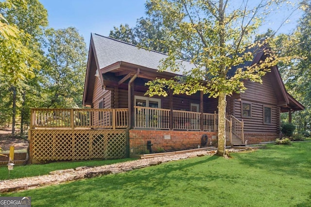 view of home's exterior featuring a deck and a lawn