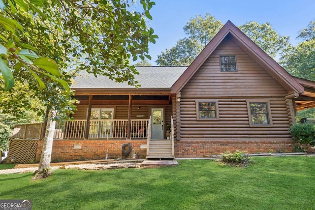 cabin with a porch and a front lawn