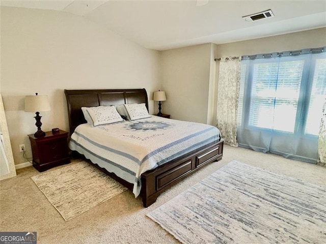 carpeted bedroom featuring lofted ceiling