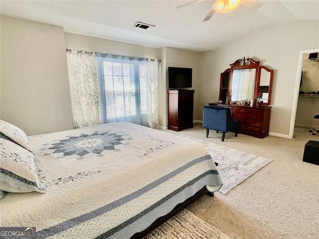 bedroom featuring light carpet, lofted ceiling, a spacious closet, and ceiling fan