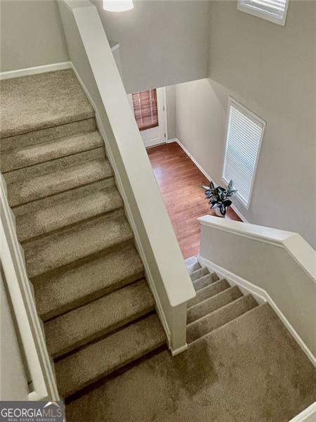 stairs featuring hardwood / wood-style flooring