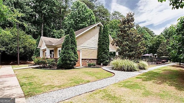 view of side of home with a yard