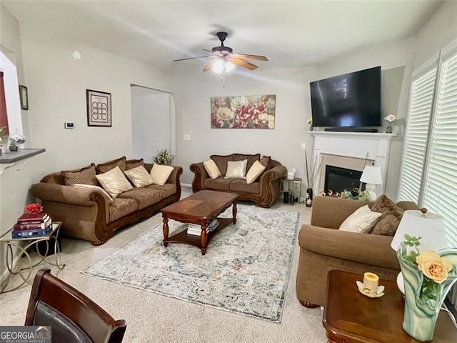 living room featuring ceiling fan and carpet