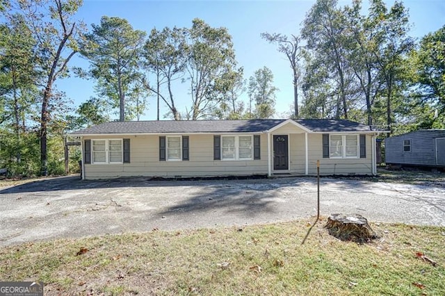 ranch-style house with a front lawn