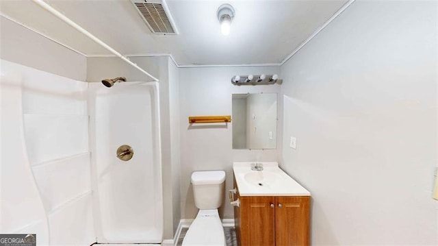 unfurnished bedroom featuring a closet, ensuite bathroom, ornamental molding, and dark hardwood / wood-style flooring