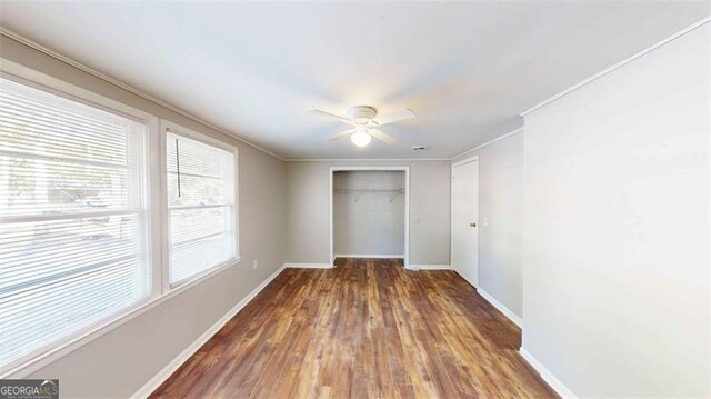 spare room with crown molding, dark hardwood / wood-style floors, and ceiling fan