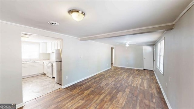 empty room featuring crown molding and wood-type flooring