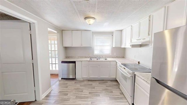 kitchen with white cabinetry, light hardwood / wood-style floors, stainless steel appliances, and a textured ceiling