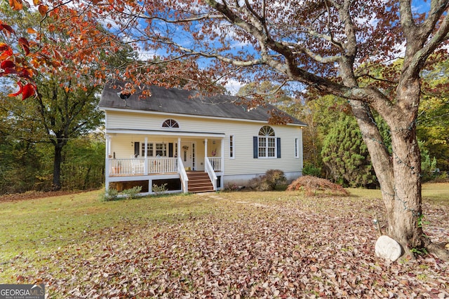 view of front of property with covered porch and a front yard