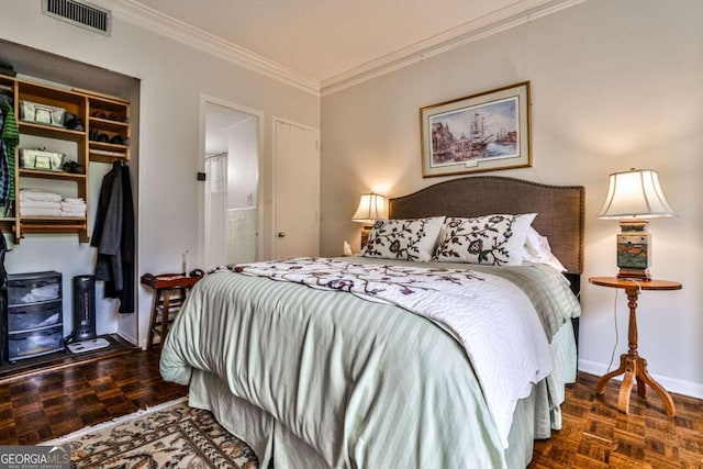 bedroom featuring a closet, crown molding, and dark parquet floors