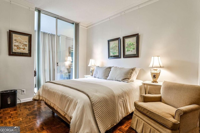 bedroom featuring crown molding and dark parquet flooring