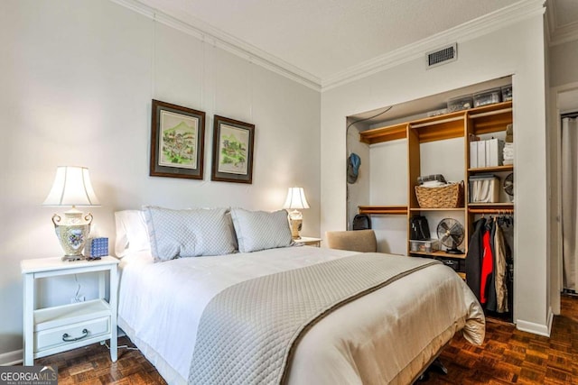 bedroom featuring a closet, crown molding, and dark parquet floors