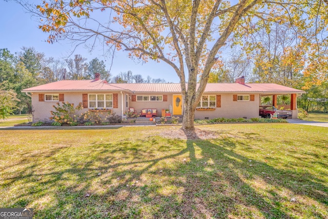 ranch-style home featuring a carport and a front lawn