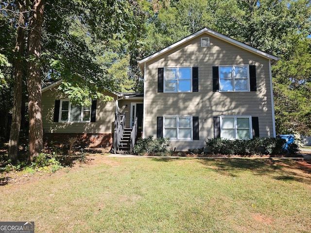 tri-level home with a front yard