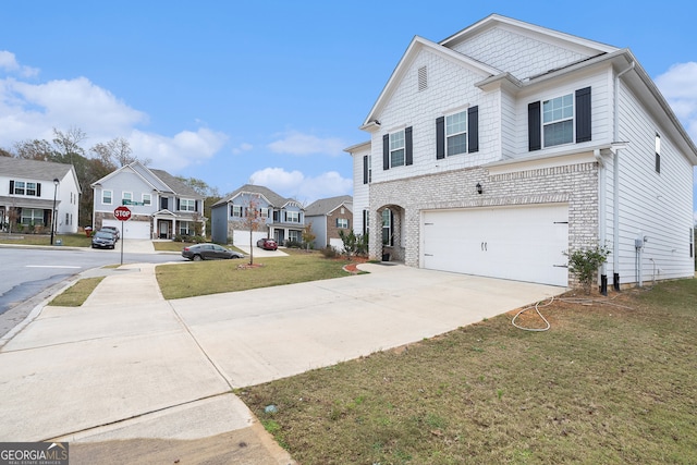 view of front of house with a garage and a front lawn