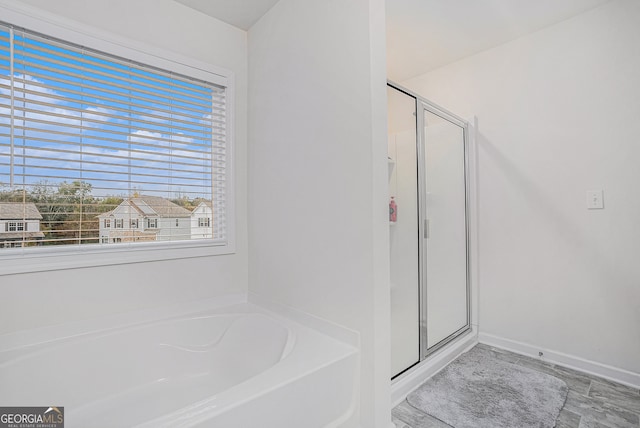 bathroom featuring separate shower and tub