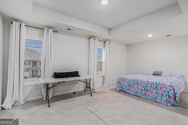 bedroom featuring multiple windows and light colored carpet