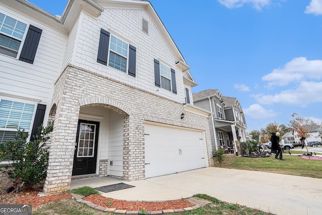 view of front of property featuring a garage and a front yard