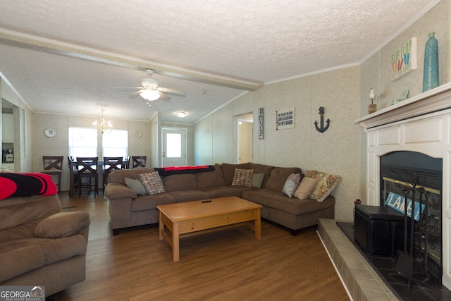 living room with crown molding, wood-type flooring, a textured ceiling, and ceiling fan with notable chandelier