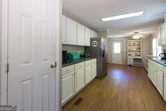 kitchen featuring white cabinets, ceiling fan, stainless steel fridge with ice dispenser, a textured ceiling, and wood-type flooring