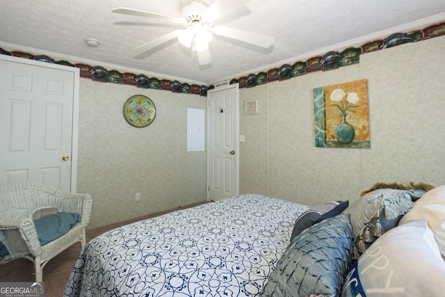 bedroom featuring crown molding, a textured ceiling, and ceiling fan