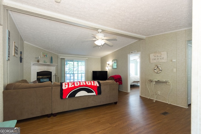 living room with lofted ceiling, a textured ceiling, dark hardwood / wood-style floors, and ornamental molding