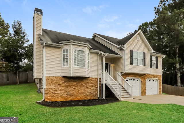 view of front of home with a front yard and a garage