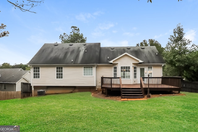 rear view of property featuring a deck, a lawn, and central AC unit