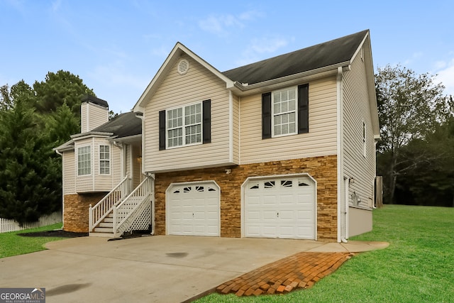 bi-level home featuring a front yard and a garage