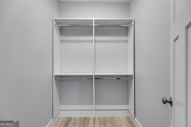 walk in closet featuring light hardwood / wood-style flooring