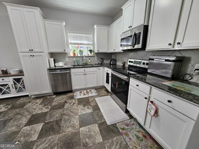 kitchen with sink, white cabinets, and appliances with stainless steel finishes