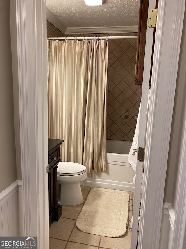 full bathroom featuring tile patterned floors, shower / bathtub combination with curtain, a textured ceiling, and toilet