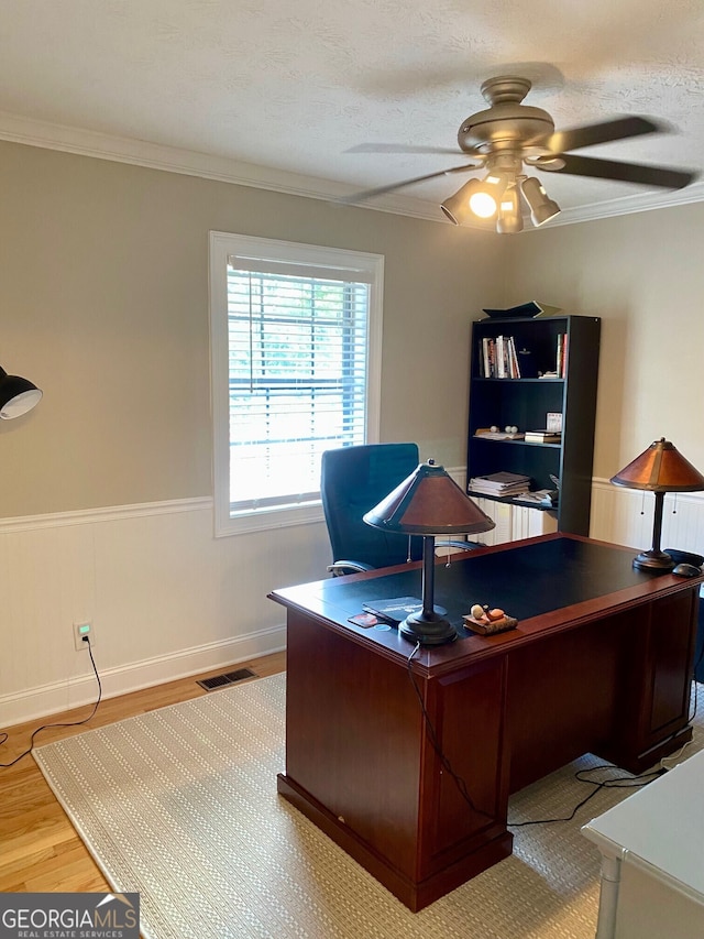 bedroom with ceiling fan, ornamental molding, and light hardwood / wood-style flooring