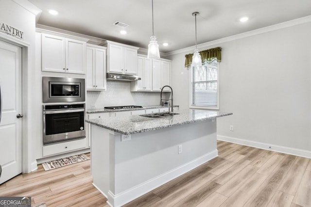 kitchen with light hardwood / wood-style floors, appliances with stainless steel finishes, sink, and white cabinets