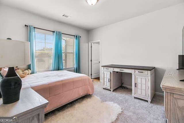 bedroom featuring light carpet