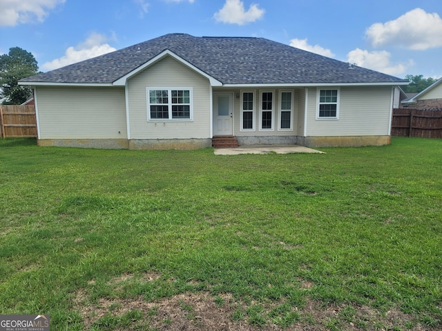 rear view of property with a yard