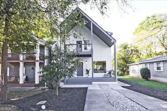 view of front of home with covered porch and a balcony