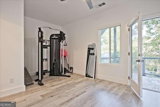 workout room featuring light wood-type flooring