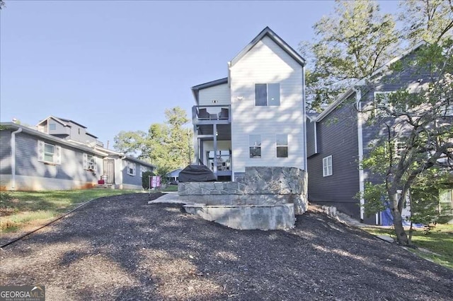 rear view of property featuring a balcony