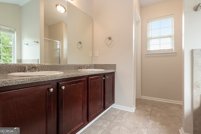 bathroom with vanity, a shower with shower door, and tile patterned floors