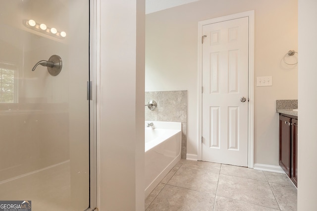 bathroom featuring vanity, independent shower and bath, and tile patterned floors