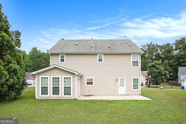 back of property featuring a yard and a patio