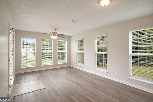 unfurnished sunroom featuring ceiling fan