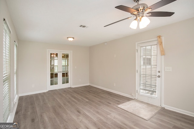 unfurnished room featuring light hardwood / wood-style floors, french doors, and ceiling fan