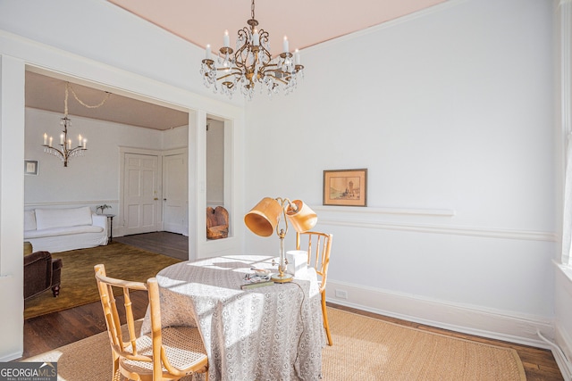 dining room with an inviting chandelier and hardwood / wood-style floors